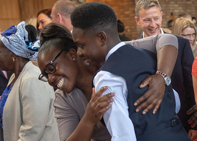 Woman hugging teenager